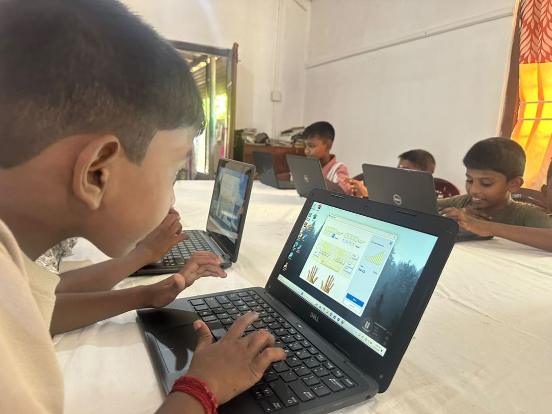 A boy practising computer skills on a laptop